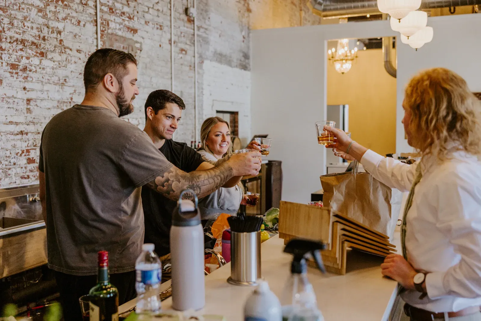 Guests toasting at the bar inside 24 Shelby, a downtown Indianapolis wedding venue, the kind of guest experience worth spending on when you plan an Indiana wedding on a budget.