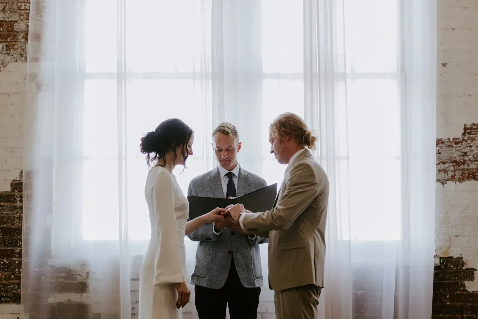 Ceremony setup at an affordable Indianapolis wedding venue with rows of wooden chairs already provided in the rental, leading down a polished aisle toward the altar.