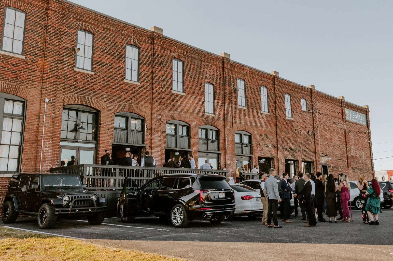 Couple portraits against exposed brick at 24 Shelby